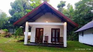 a small house with a red roof at Walwa palm villa in Udawalawe