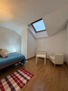 a bedroom with a bed and a skylight at Ático luminoso en Felechosa in Felechosa
