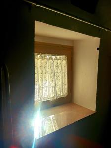 a window with a curtain in a room at Trulli Donna Grazia in Martina Franca