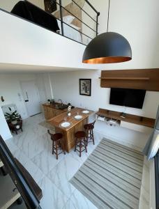 a dining room with a table and chairs and a television at Apartamento Texas in Pomerode