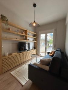 a living room with a couch and a tv at Karpenisi Nest in Karpenisi
