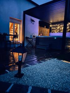 a night view of a patio with a tub and a table at PrestigeLodgesFontainebleau, Maison polynésienne & jacuzzi privé in Pamfou