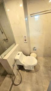 a bathroom with a toilet and a sink and a shower at kodus hotel boutique in Pattaya South