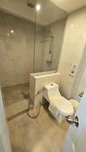 a bathroom with a shower and a toilet and a shower at kodus hotel boutique in Pattaya South