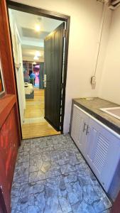 a door leading into a room with a hallway at kodus hotel boutique in Pattaya South +24 photos