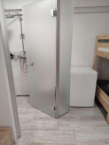 a bathroom with a refrigerator and a trash can at Sesvete Studio w Garden View in Sesvete +6 photos