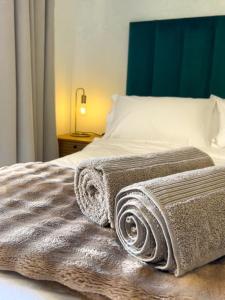 a bed with two towels on top of it at Secret Eden in Jeffreys Bay +11 photos