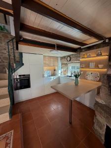 a kitchen with a wooden table in a room at A Palleira in San Amaro +26 photos