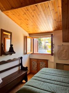 a bedroom with a bed and a wooden ceiling at Casa Bianca in Pescocostanzo
