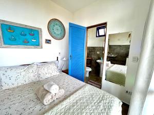 a bedroom with a bed with a towel on it at Lar da Lara in Ilhabela