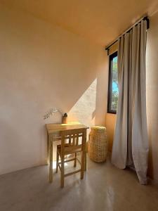 a table and a chair in a room with a window at Casa Melon 1BR Spectacular Private Oceanview Terrace in Santa María Colotepec