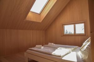 a bed in a room with a window at Z91 - Skandi-Architektenhaus mit Bergblick in Bad Mitterndorf