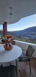 a room with a table and a chair and a view at Vikendica Kod Koje in Banja Luka