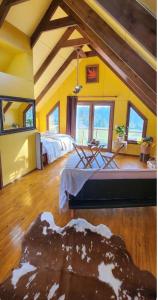 a large room with two beds in a room at Cabaña fundo Mohr in Pichil