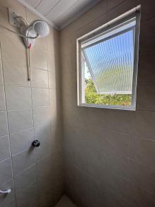 a bathroom with a shower and a window at Com churrasqueira em Canasvieiras in Florianópolis +150 photos