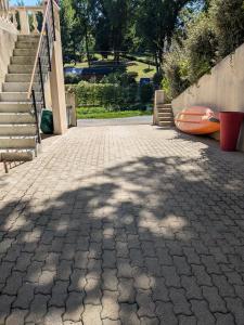 a shadow of a tree on a brick sidewalk at Grande Suite Privée - Entrée indépendante - SDB & WC privatifs in Fondettes