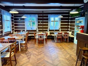 a dining room with wooden tables and chairs at Chata Amálka in Rokytnice nad Jizerou +15 photos