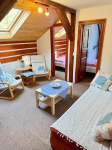 a room with two beds and a table and chairs at Chata Amálka in Rokytnice nad Jizerou