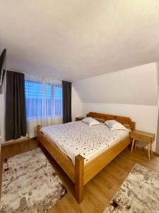 ein Schlafzimmer mit einem Bett und einem großen Fenster in der Unterkunft Pensiunea Pusu in Ranca + 42 Fotos