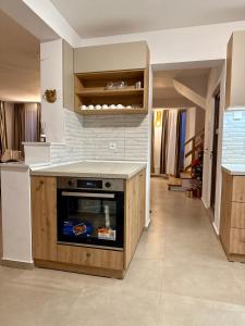 a kitchen with a stove and a counter top at Pensiunea Pusu in Ranca