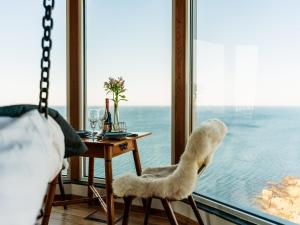 a room with a chair and a table and a window at Falknästet in Höganäs +1 photo