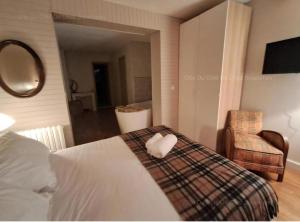 ein Schlafzimmer mit einem Bett mit einem herzförmigen Handtuch in der Unterkunft Gîte Du Côté de Chez Souesmes in Souesmes