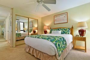 a bedroom with a large bed and a mirror at Kaleialoha 211 · KA 211 OceanFront 1BD Whale Watch Relax Getaway in Kahana +43 photos