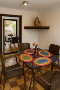 a dining room with a table with a colorful plate on it at Los Robles in Tepoztlán +29 photos