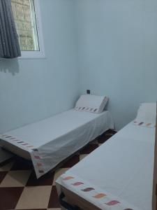 Ένα ή περισσότερα κρεβάτια σε δωμάτιο στο agadir location vacance aourir plage