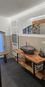 a bathroom with a sink on a wooden table at Haus Tisch in Schruns-Tschagguns +65 photos