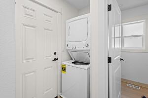 una lavanderia bianca con lavatrice e asciugatrice di Seaside Getaway A a Seaside Altre 67 foto