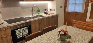 a kitchen with a table and a sink at Bella Cortina - comodo al centro e impianti, con garage in Cortina dʼAmpezzo