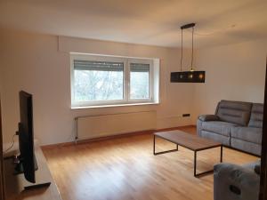 a living room with a couch and a table at Ferienwohnung "Tilda" auf Hof Elseblick in Bünde