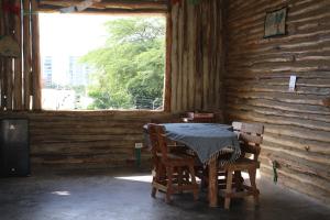 a table and two chairs in a room with a window at Casa Grulla in Santa Marta +31 photos