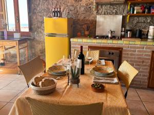 a table with food and a bottle of wine at Attico con vista unica in Scalea +10 photos