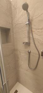 a shower with a shower head in a bathroom at Bella Cortina - comodo al centro e impianti, con garage in Cortina dʼAmpezzo +12 photos
