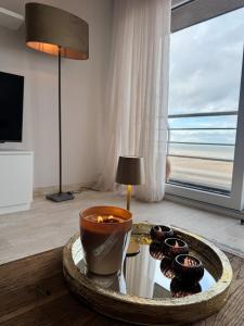 a room with a table with a candle and some donuts at Studio in Wenduine with frontal sea view in Mellet +1 photo