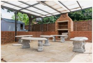 a patio with concrete tables and a brick wall at Ekuhlaleni Room 6 in Pretoria