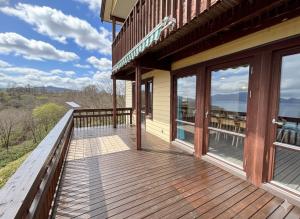 a large deck with a view of the water at Cloud9 Toya in Lake Toya