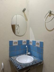 a bathroom with a sink and a mirror at Hostel IndiaJara in Itacaré