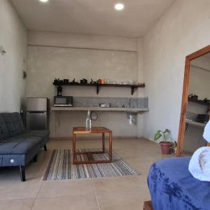 a living room with a couch and a table at La Familia Casa and Suites in Holbox Island