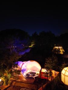 an igloo is lit up at night at Bubble Glamping Sicily in Catania