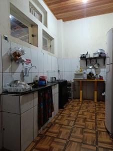 a large kitchen with wooden floors in a room at Hostel IndiaJara in Itacaré +26 photos