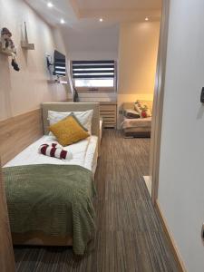 a small bedroom with a bed and a window at Tri-M Konaci in Kopaonik +73 photos