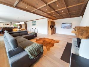 a living room with a couch and a wooden table at Luxuriöses Penthouse in Davos modern hochwertig in Davos