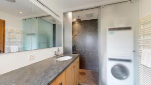 a bathroom with a sink and a shower at Luxuriöses Penthouse in Davos modern hochwertig in Davos +28 photos