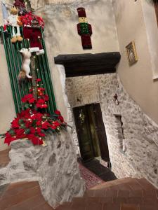 a stone fireplace with christmas decorations and a door at Il Vicoletto in Artena