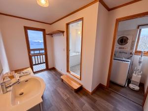 a bathroom with a sink and a large window at Cloud9 Toya in Lake Toya +27 photos