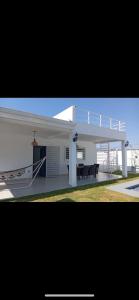 a white house with a porch and a patio at Villa Karol in Rivas