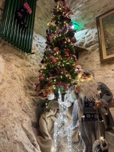 a christmas tree with a santa clause next to it at Il Vicoletto in Artena